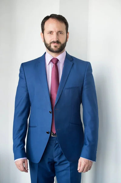 Man with beard in blue formal suit