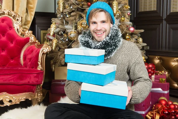 Ο άνθρωπος με το καπέλο, πουλόβερ χαμόγελο με τυλιγμένα δώρα — Φωτογραφία Αρχείου