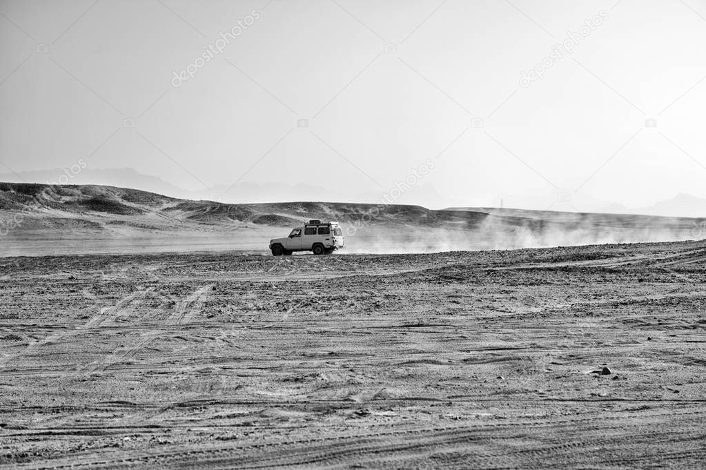 White safari jeep car in sand dune