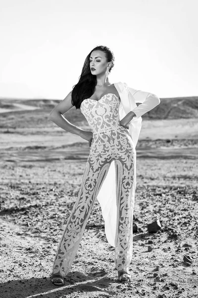 Girl in dress in sunny desert. Woman in white dress in sand dunes. Wedding fashion and beauty salon. Bride and wedding ceremony. Elegance and fashion model.