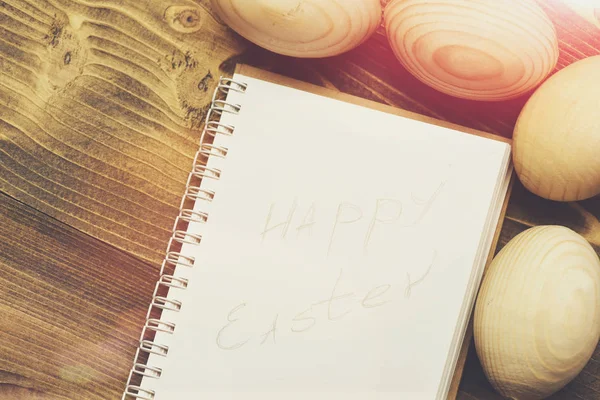 paper notebook and easter wooden eggs, cooking and menu design