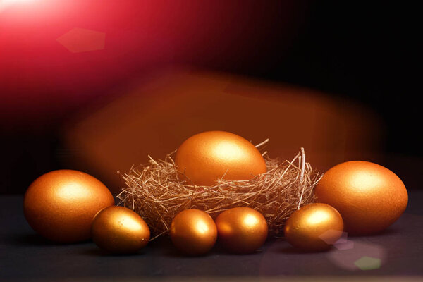traditional eggs painted in golden color inside nest