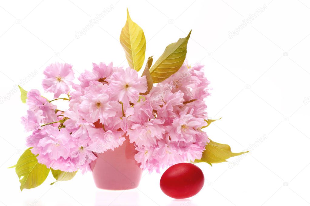 Traditional Easter egg in red with bouquet of pink sakura
