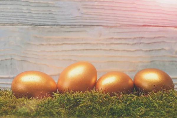 traditional easter golden eggs on wooden background