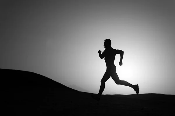 Running man silhouette at sunset sky — Stock Photo, Image