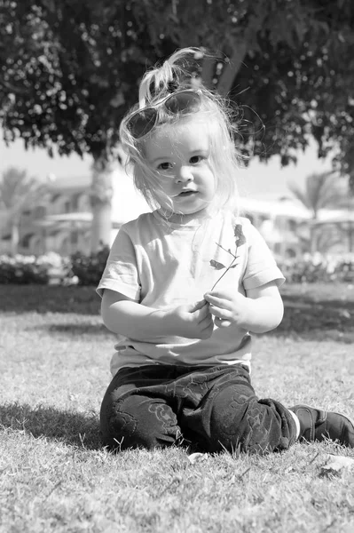 Niño pequeño con cara adorable en hierba verde — Foto de Stock