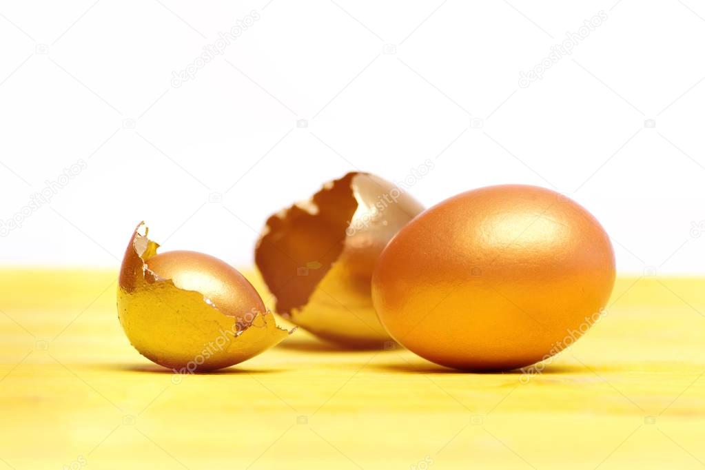 broken easter golden egg shell, future life, luxury and success
