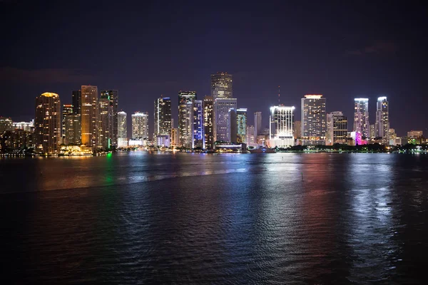 Panorama dello skyline di Miami di notte, Stati Uniti. L'illuminazione di grattacieli riflette su acqua di mare in crepuscolo. Architettura, struttura, design. Edilizia, costruzione, sviluppo. Wanderlust, viaggio, scoperta — Foto Stock