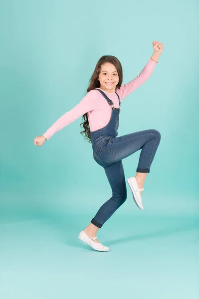 Happy child in jeans overall dance, fashion — Stock Photo, Image