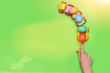 female hand with colorful easter eggs in lorry car toy clipart