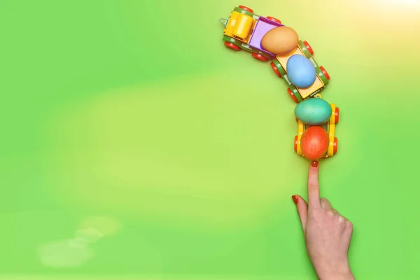Kvinnlig hand med färgglada påskägg i lastbil bil leksak — Stockfoto