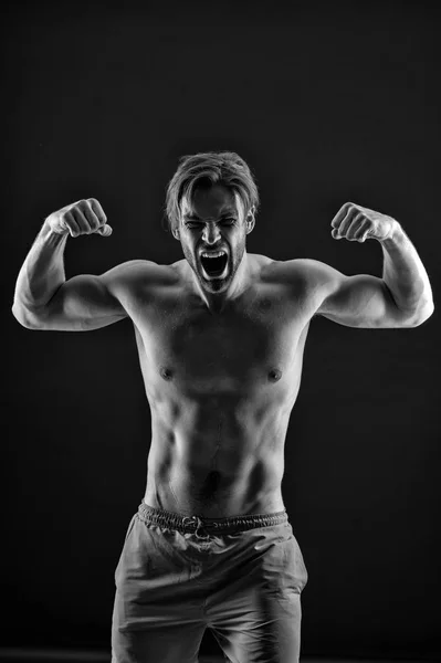 Angry athlete show strong triceps and biceps muscles. Bearded man shout with anger, health. Sportsman with fit bare torso, fitness. Mens health, bodycare, wellness, black and white — Stock Photo, Image