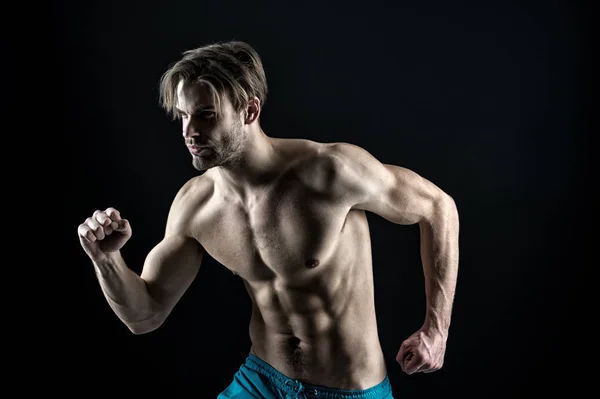 Sexy macho in running position, sport. Bearded man with fit bare torso and belly, fitness. Sportsman with six pack muscles, sport. Athlete training with energy and power, vintage — Stock Photo, Image