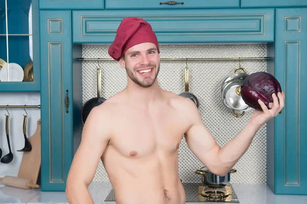 Happy chef with sexy torso cook in kitchen. Man smile with purple cabbage. Vegetable for cooking dishes. Food preparation and cooking recipes. Cuisine menu and healthy diet — Stock Photo, Image