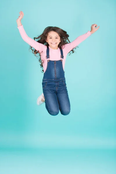 Happy child in jeans overall jump, fashion — Stock Photo, Image