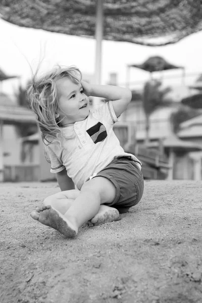Παιδί παιχνίδι ξυπόλητοι σε αμμώδη παραλία ηλιόλουστη ημέρα — Φωτογραφία Αρχείου