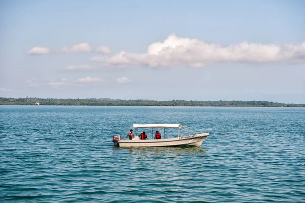 Santo tomas, Guatemala - 23 février 2016 : les gens voyagent en bateau à moteur en mer bleue sur un ciel nuageux. Voyager en bateau, le transport maritime. Vacances d'été et wanderlust — Photo