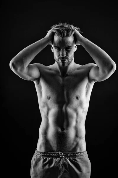 Black and white, studio shoot of strong athletic man on dark background — Stock Photo, Image