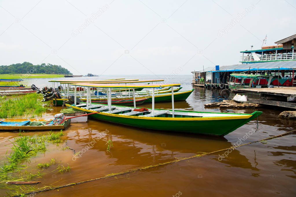 Motorboats or boats moored at sea shore in manaus, brazil. Water transport and vessel. Summer vacation and sea travel. Wanderlust adventure and discovery