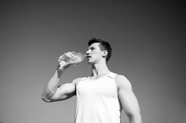 Uomo che beve acqua dalla bottiglia nella giornata di sole — Foto Stock