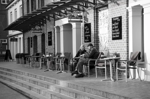 与老夫妇喝咖啡在表在户外的街头咖啡厅 — 图库照片