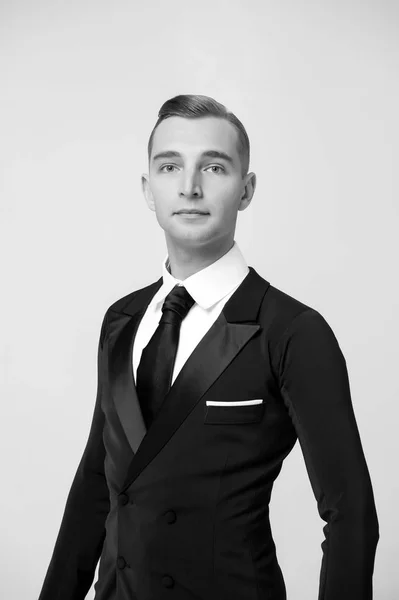 Groom dressed for wedding or holiday celebration. Ballroom dancer in stylish tuxedo. Man in elegant suit with tie. Dress code for businessman. Fashion style and trend concept, black and white — Stock Photo, Image