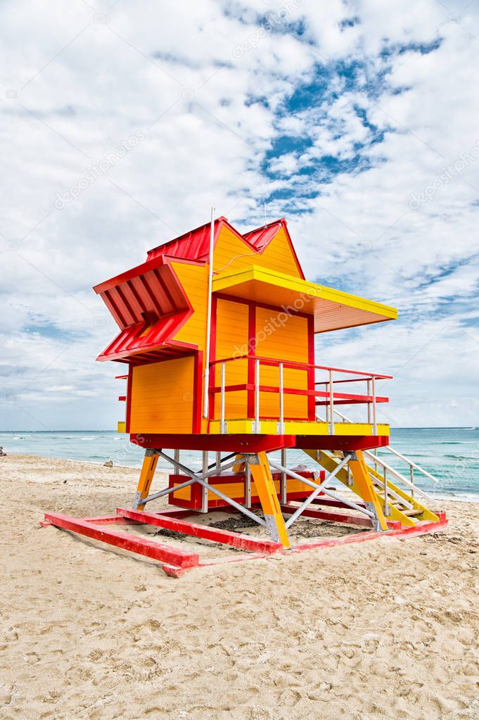 Lifeguard house on sand beach in miami, usa. Tower for rescue baywatch in typical art deco style. Wooden house on ocean shore on cloudy sky. Summer vacation concept. Public guarding and safety