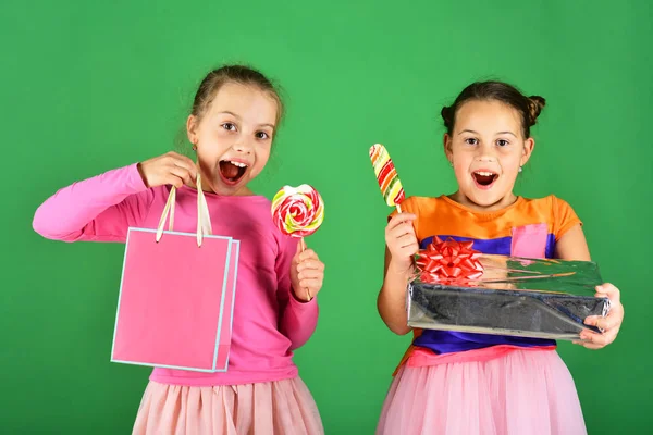 Sweet presenta el concepto. Chicas con caras excitadas posan con caramelos — Foto de Stock