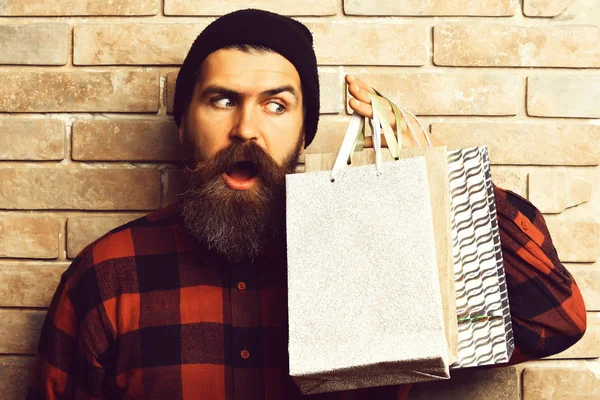 Бородатый брутальный кавказский хипстер с усами, держащий покупки. — стоковое фото