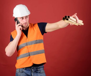 Müzakere kavramı. Mühendis, mimar, Oluşturucu meşgul yüzündeki konuşuyor smartphone cep telefonu ile ayrı tutma planları, kopya alanı iken. Dostum, kask içinde mimar inşaat telefon, kırmızı zemin üzerine denetler