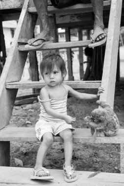 Çocuk ahşap merdivenlerde tembellik yeşil yaprakları ile besleme