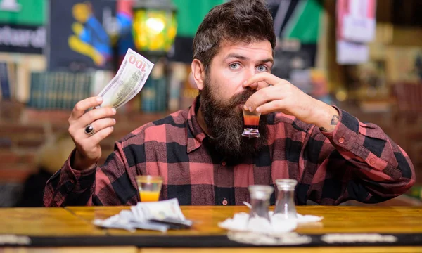 Hipster on pensive face drinks shot cocktail. — Stock Photo, Image