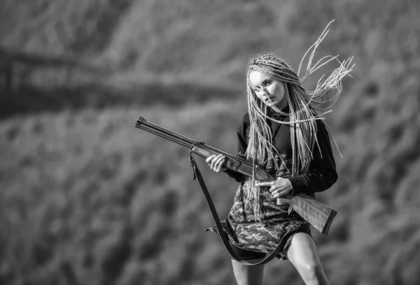 Hunting season. Woman attractive long hair pretty face hold rifle for hunting. Dangerous girl. Defending concept. Sexy warrior. She is warrior. Warrior mountains landscape background. Feminist girl — Stock Photo, Image