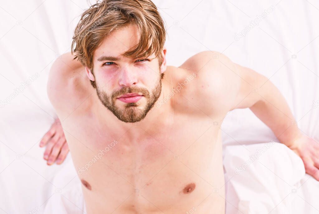 Picture showing young man stretching in bed. Man stretching in bed. Man morning bed.
