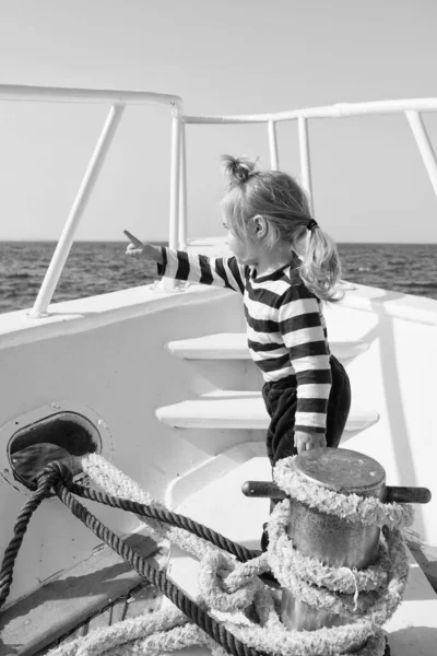 traveling adventures and wanderlust. funny kid in striped marine shirt. happy little boy on yacht. boat trip by sea. summer vacation. childhood happiness. little sailor on boat. wanderlust concept
