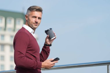 - Kahve hazır. Yakışıklı adam hazır kahveyi tutar. Olgun iş adamı şehir dışında kahve içer. Taze kahvenin tadını çıkarıyorum. İşten izin al, boşluğu kopyala