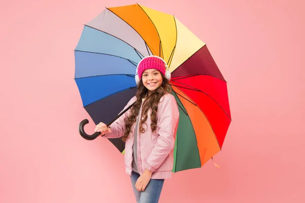 Muzyka zawsze przy mnie. Codzienna zabawa. Dziecko lubi proste rzeczy. Baw się dobrze. Fajny pomysł. Dobrze się czuję. Dziewczyna bawiąca się spacerując bezprzewodowe słuchawki pod kolorowym parasolem. Wypoczynek jesienny — Zdjęcie stockowe