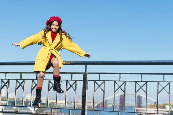 Find balance. Childhood is about happy memories. Smiling little kid in hat sky background. Small girl wear fall outfit outdoors. Autumn bucket list. Last autumn beams. Ideas for autumn leisure