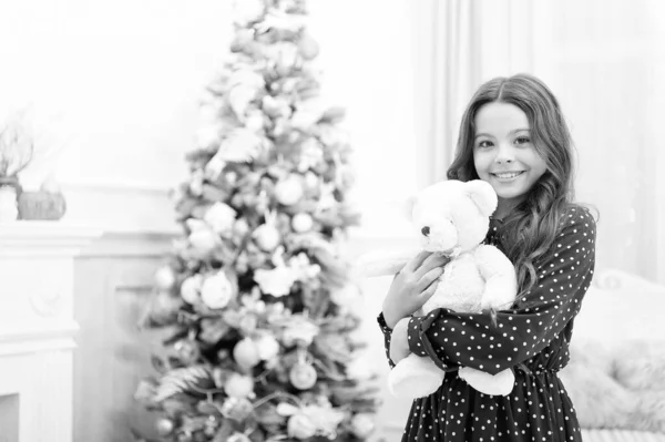 Cute little child girl with xmas present. The morning before Xmas. waiting for santa. Winter. happy new year. Christmas shopping. christmas family holiday. By golly, be jolly