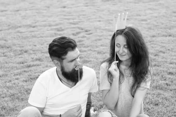 Youth day. Carefree couple having fun green lawn. Couple in love cheerful youth booth props. Man bearded hipster and pretty woman cheerful faces. Summer entertainment. Emotional people. Couple dating