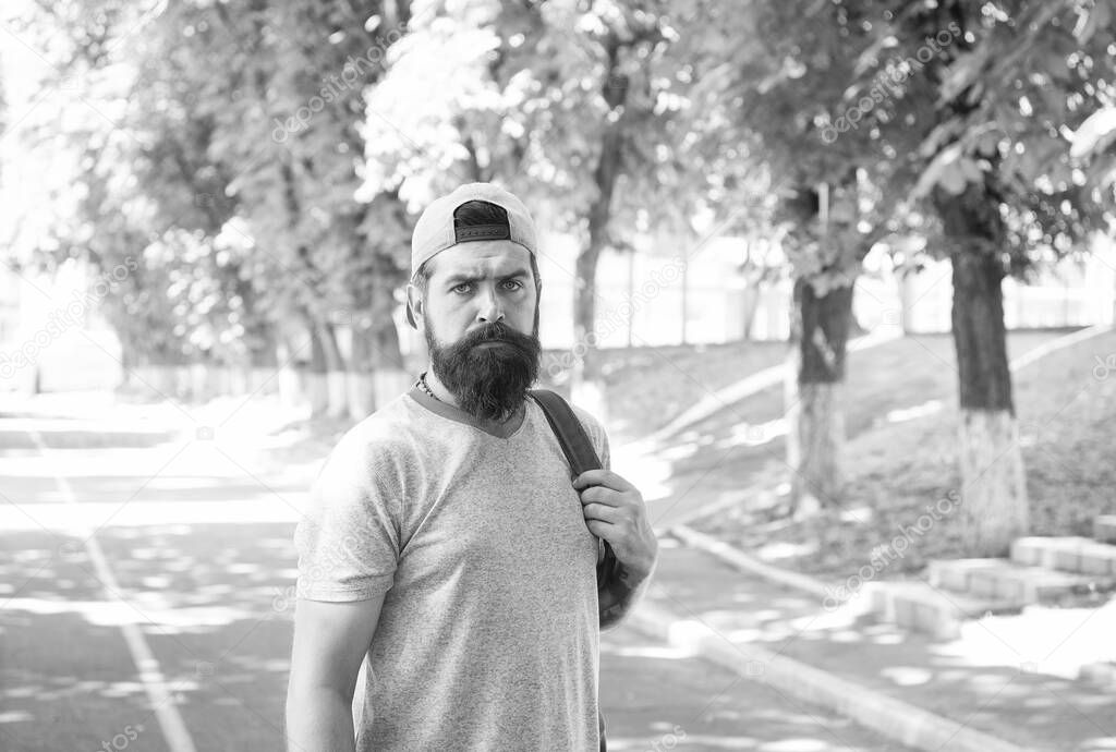 Bearded and brutal. Bearded man on urban background. Serious bearded hipster in casual style on summer outdoor. Caucasian guy wearing mustache and beard on bearded face