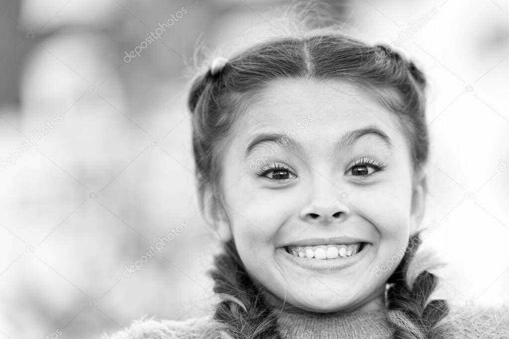 Because of your smile, you make life more beautiful. Adorable little girl with big smile. Smiling kid with white healthy smile on beautiful face. Cute small child with braided hair and happy smile