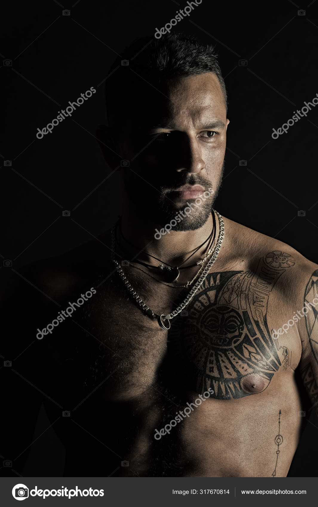 Fit model with tattoo design on skin. Bearded man with tattooed chest. Man  with sexy muscular torso. Sportsman or athlete with stylish beard and hair.  Bodycare or wellness and sport, vintage filter