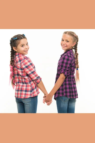 Happiness is friendship. Happy children hold hands isolated on white. Little girls enjoy friendship. International friendship day. Friendship bonds. Childhood friends