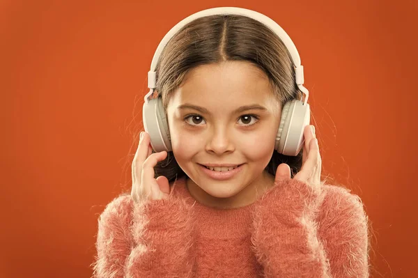 La música moderna es su estilo de vida y placer. Niña moderna con auriculares bluetooth. Pequeño niño escuchando música en la vida cotidiana. Usando la tecnología moderna en la vida diaria. La vida moderna —  Fotos de Stock