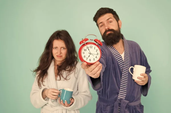 Its coffee time. Man with beard and sleepy woman enjoy morning coffee or tea. Guy in bath clothes hold tea coffee. Breakfast concept. Every morning begins with coffee. Couple in bathrobes with mugs
