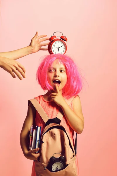 Back to school concept. Schoolgirl with red alarm on head — Stock Photo, Image