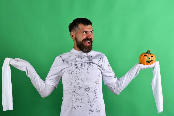 Man with evil face expression on green background