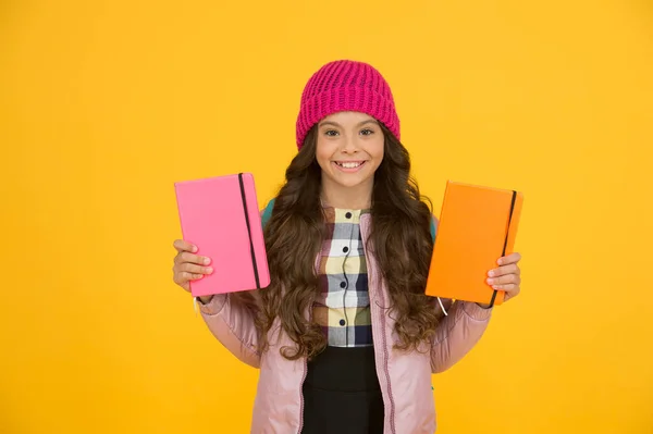 Schoolgirl with textbooks. Little smiling girl hold books. Future textbooks modern education. Textbook useful in learning environment. School creating textbooks generation. Active role in curriculum — Stock Photo, Image