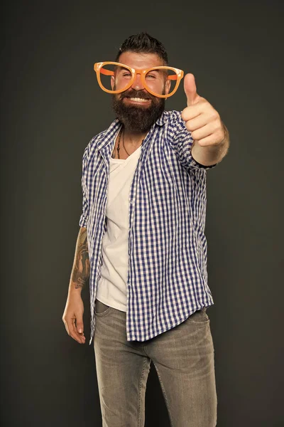 Bearded man wearing party glasses. Funny hipster in extravagant glasses. Fashion man with beard. Playful guy enjoying party. Funny glasses accessory. Entertaining himself. Only fun on my mind